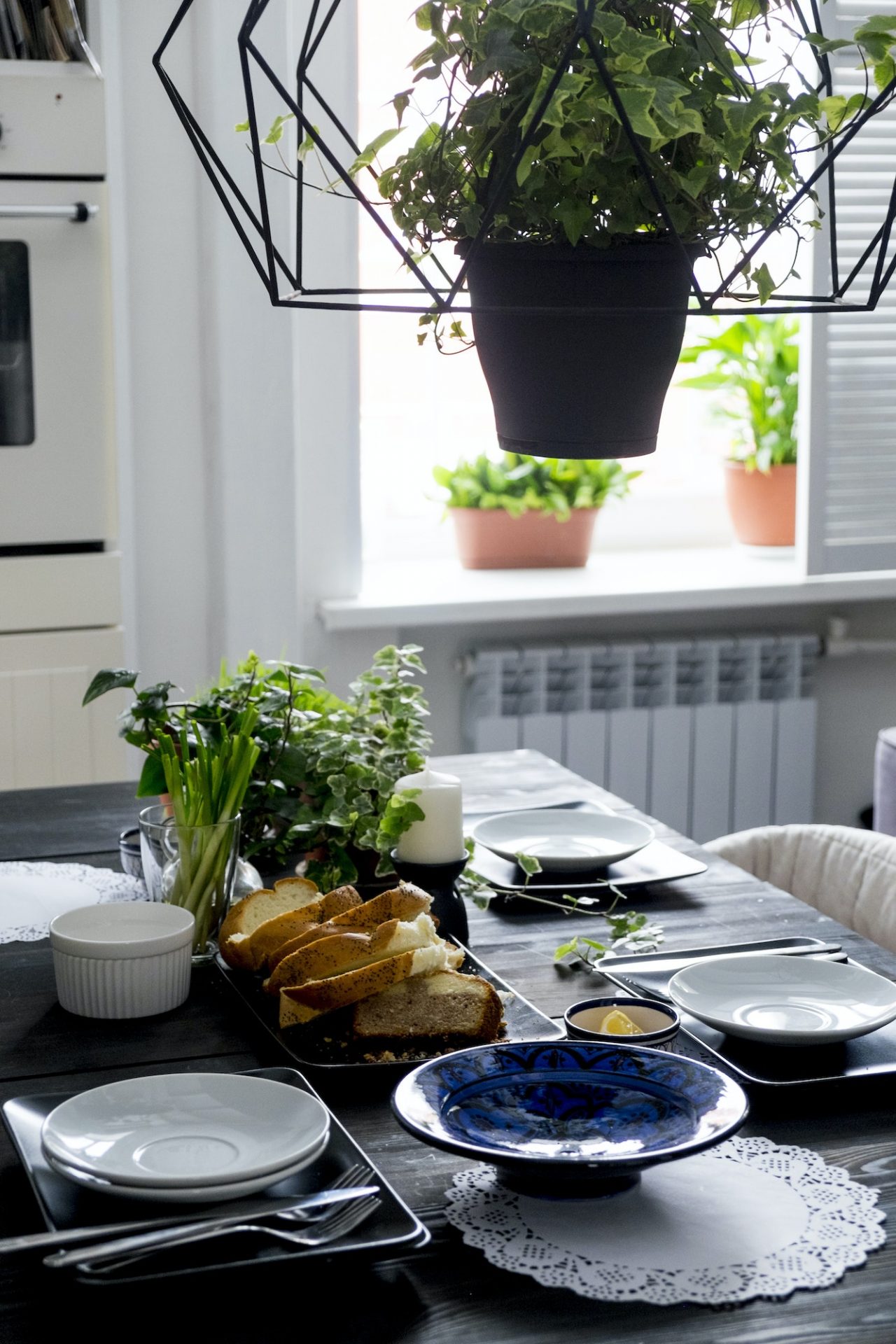 set kitchen table with bread slices fresh herbs and spring onions